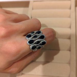 Genuine Blue Sapphire and white zircon rhodium plated sterling silver ring.